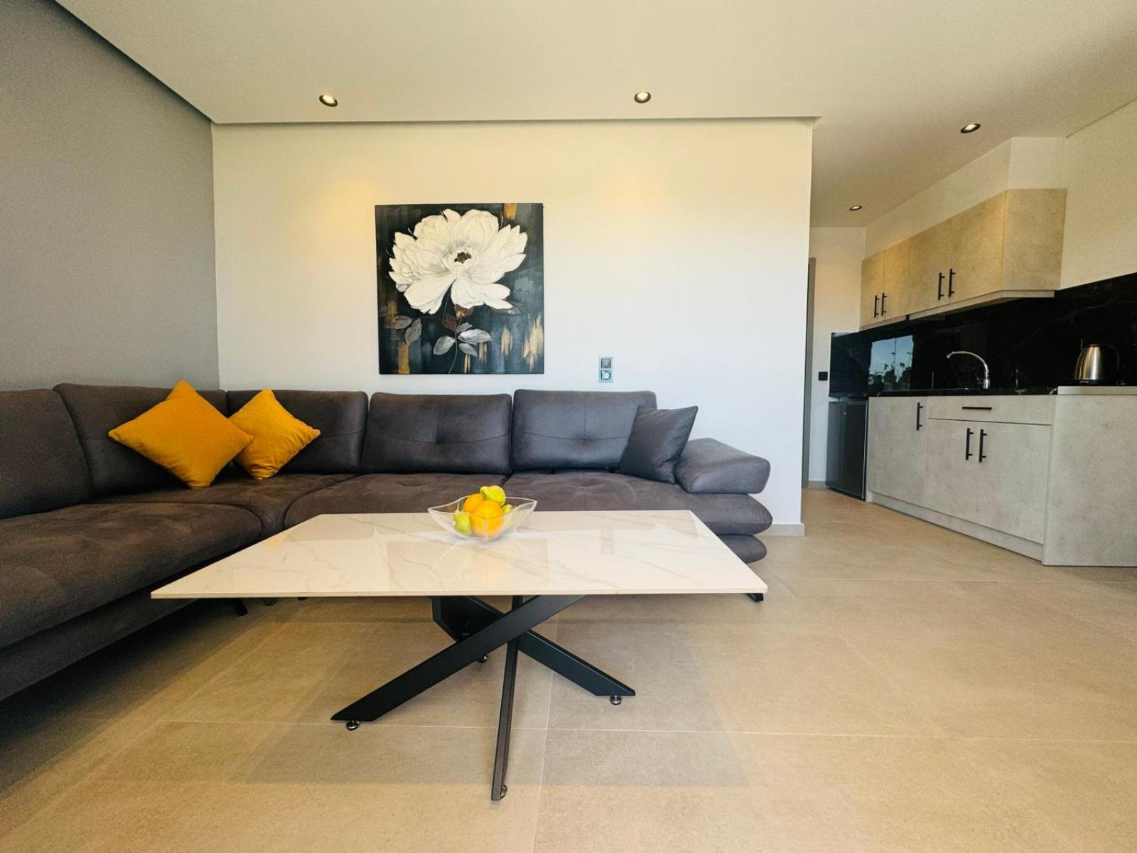 Deluxe Apartment living room with corner sofa and open kitchen