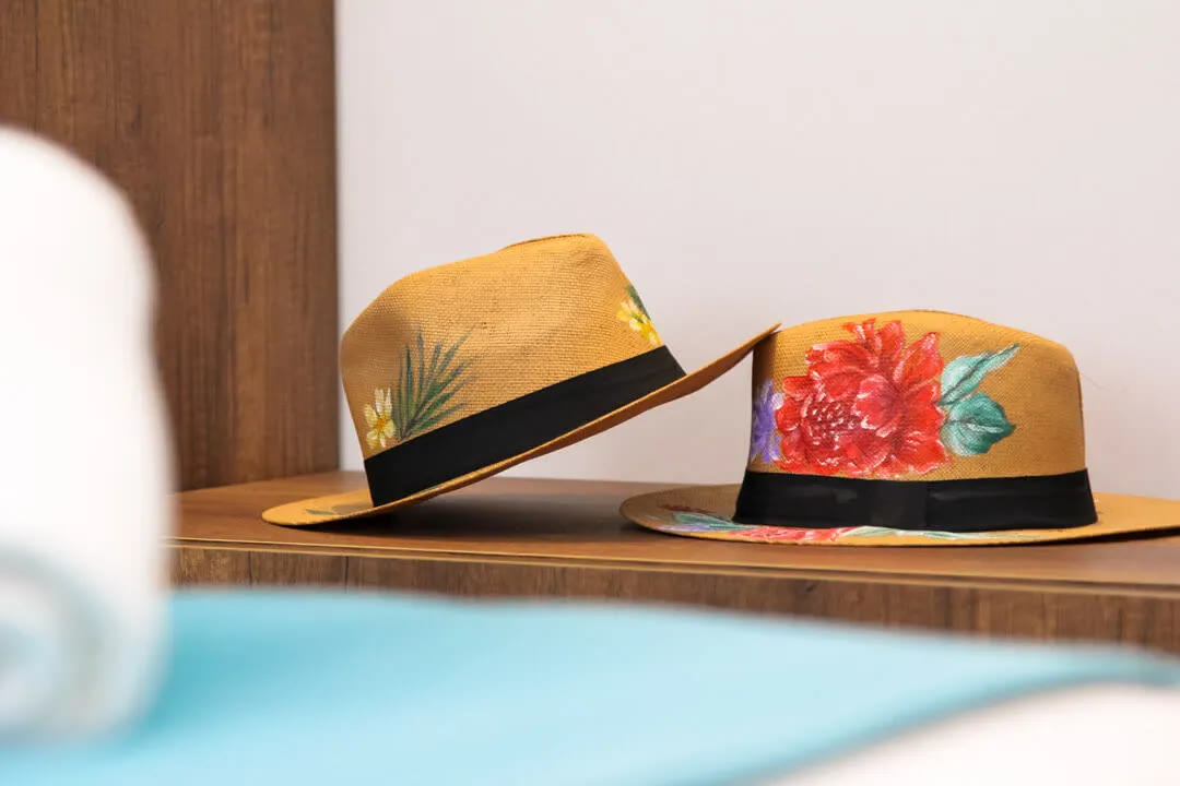 Hand-painted straw hats in a Joy apartment